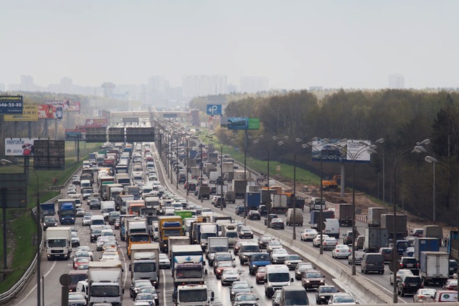 A large cluster of cars on the highway