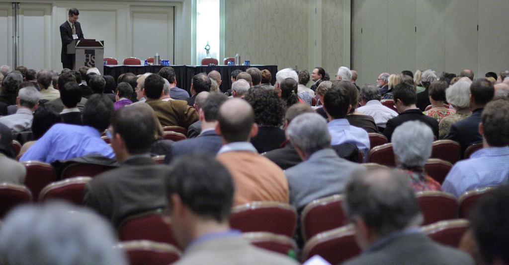 A scientist speaks to an audience.
